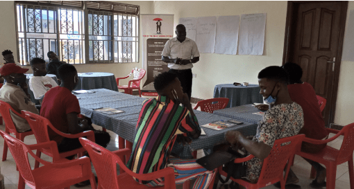 Facilitator taking participants through the session in Mukono District
